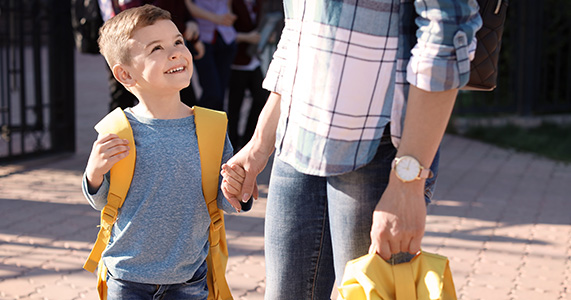 working dad dropping son off at school